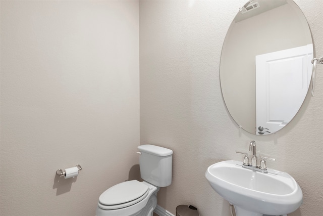 bathroom featuring toilet and sink