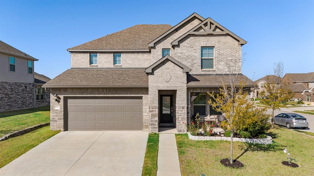 view of front of house featuring a front yard and a garage