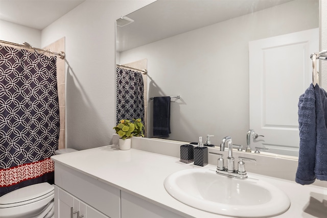 bathroom with vanity and toilet