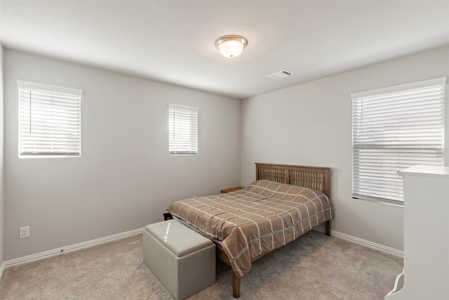 bedroom with light colored carpet