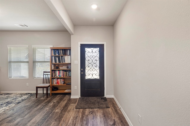 entrance foyer with beam ceiling and dark hardwood / wood-style floors