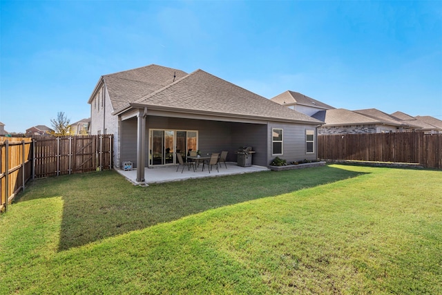 rear view of property featuring a patio area and a yard