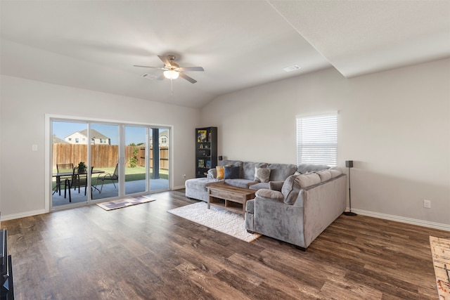 living room featuring ceiling fan, vaulted ceiling, and dark hardwood / wood-style flooring