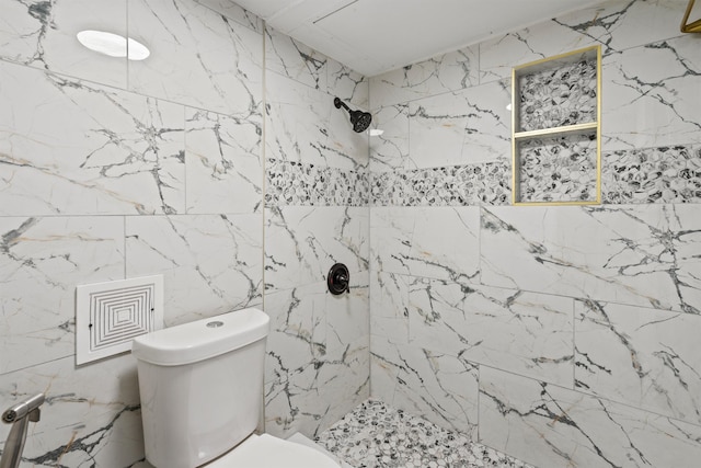 bathroom featuring toilet and tiled shower