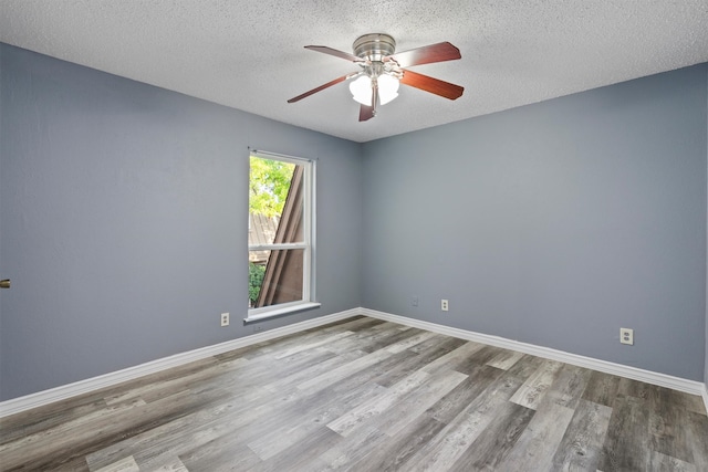 unfurnished room featuring hardwood / wood-style floors, ceiling fan, and a textured ceiling