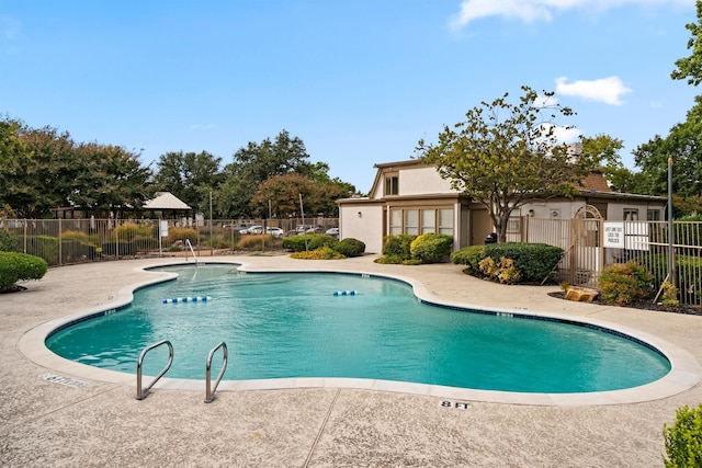 view of swimming pool featuring a patio area