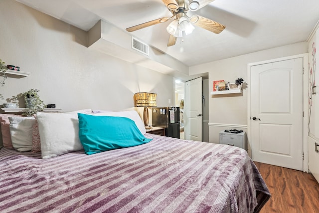 bedroom featuring dark hardwood / wood-style flooring and ceiling fan