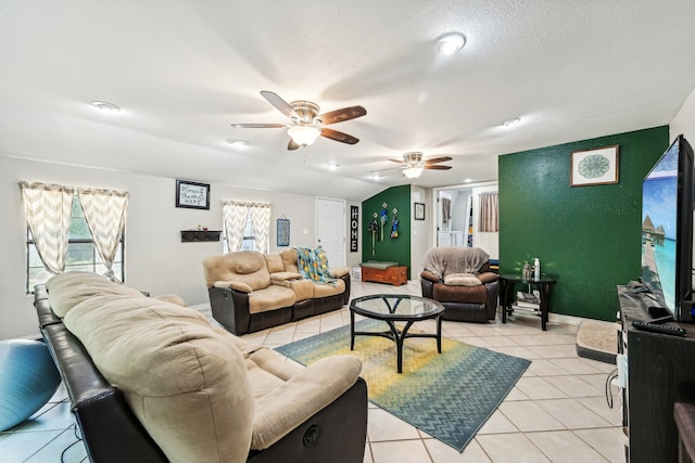 tiled living room with a textured ceiling and ceiling fan