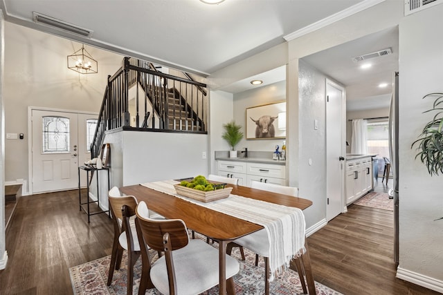 dining area with dark hardwood / wood-style floors and a chandelier