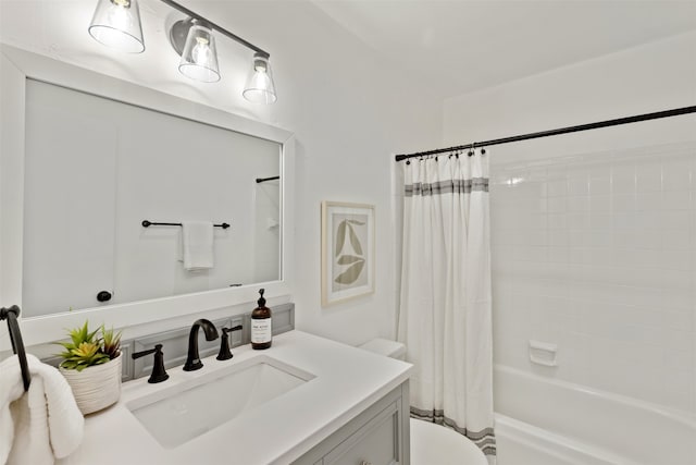 full bathroom featuring shower / bath combo with shower curtain, vanity, and toilet