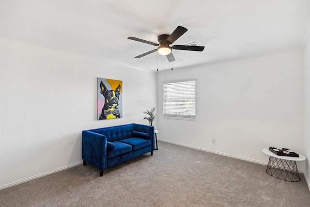 sitting room featuring carpet and ceiling fan