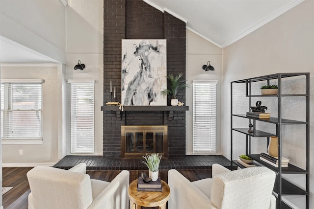 living room with a fireplace, ornamental molding, dark wood-type flooring, and lofted ceiling