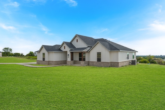 modern farmhouse style home with a front lawn and central AC