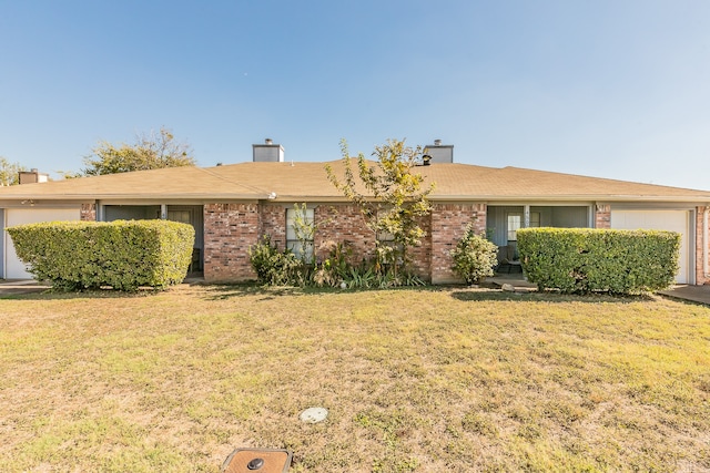 single story home featuring a garage and a front yard