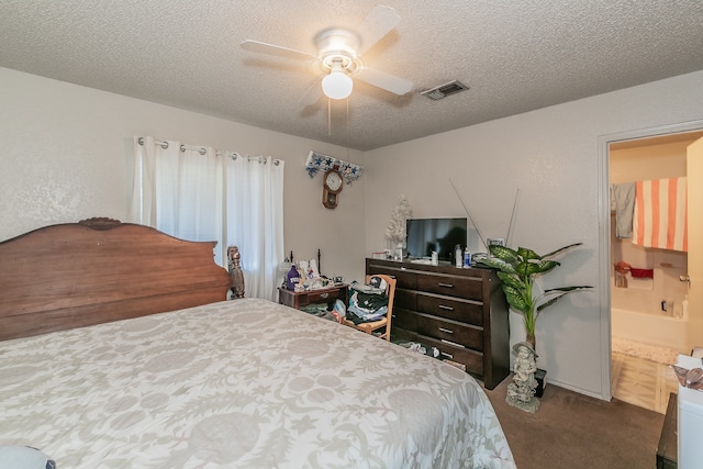 carpeted bedroom featuring ensuite bathroom, ceiling fan, and a textured ceiling