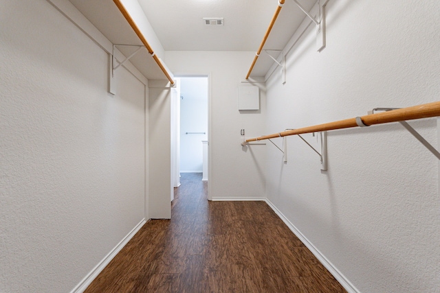 spacious closet with dark hardwood / wood-style floors