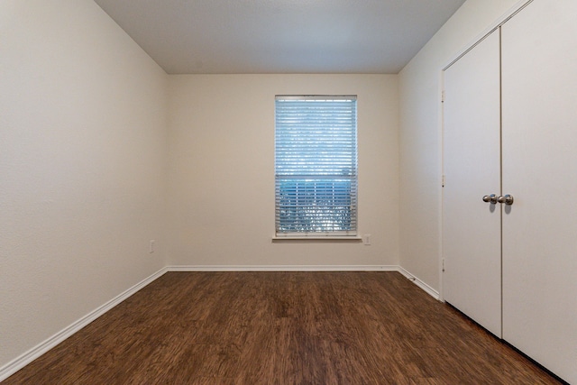 unfurnished bedroom featuring dark hardwood / wood-style floors