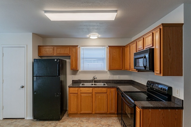 kitchen with a textured ceiling, black appliances, and sink