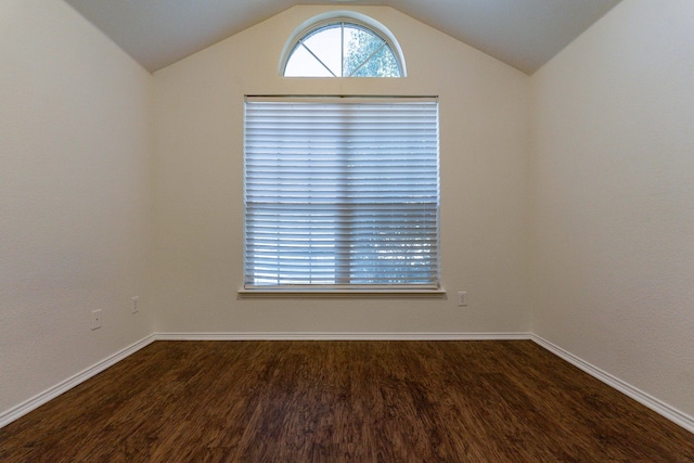 empty room with hardwood / wood-style floors and vaulted ceiling