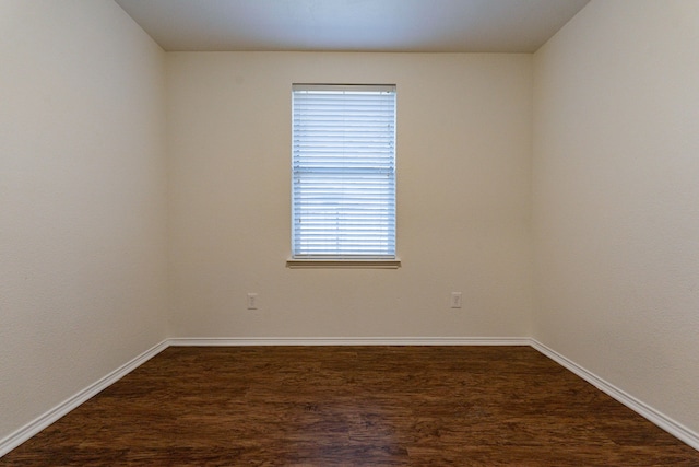 empty room featuring dark hardwood / wood-style flooring