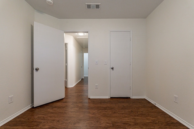 unfurnished bedroom featuring dark hardwood / wood-style flooring