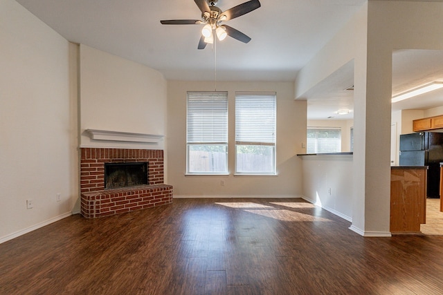 unfurnished living room with ceiling fan, a fireplace, and dark hardwood / wood-style flooring