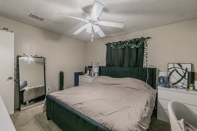 carpeted bedroom with a textured ceiling and ceiling fan