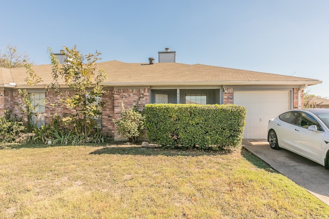 ranch-style house featuring a front yard and a garage