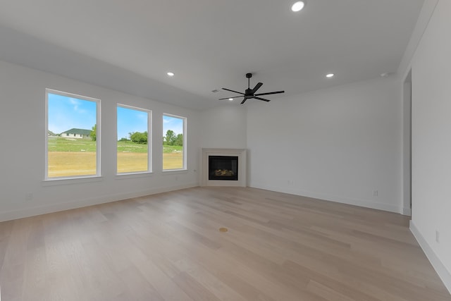 unfurnished living room featuring ceiling fan and light wood-type flooring