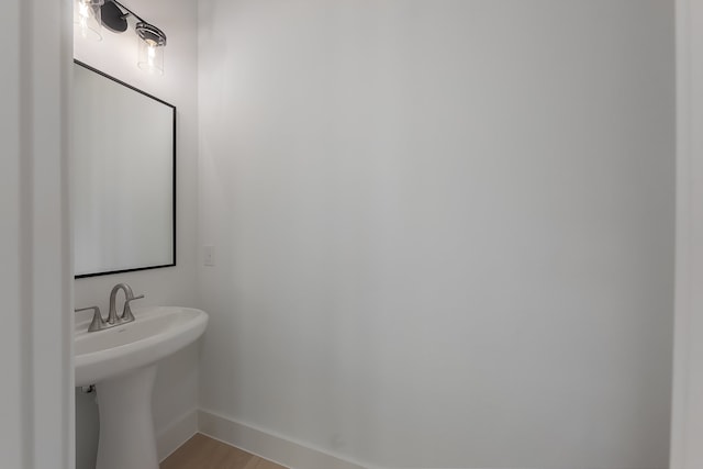 bathroom with hardwood / wood-style floors