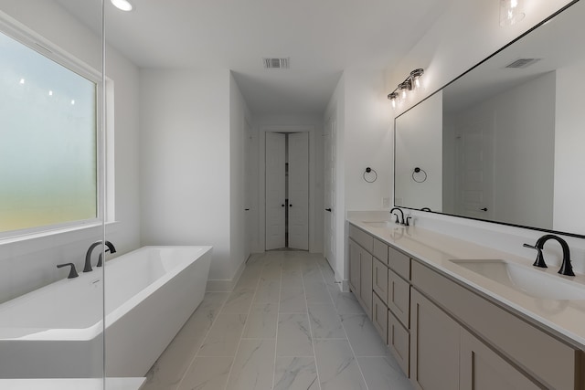 bathroom with vanity and a bath