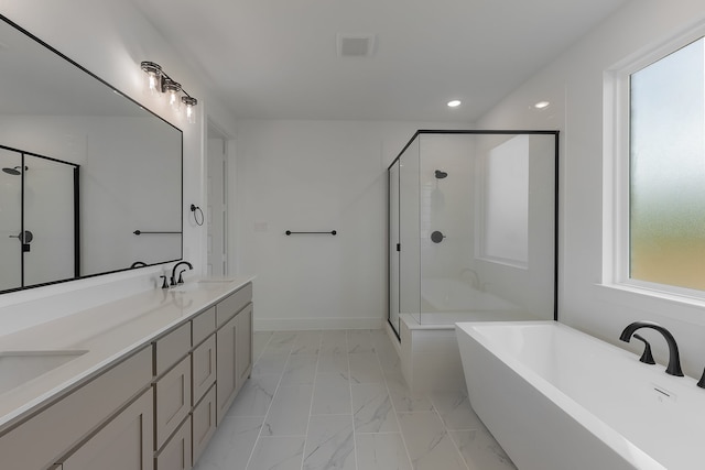 bathroom featuring vanity, shower with separate bathtub, and a wealth of natural light