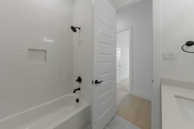 bathroom with vanity, tiled shower / bath combo, and hardwood / wood-style floors