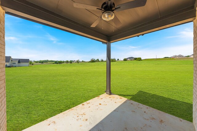 view of yard featuring a patio area, a rural view, and ceiling fan