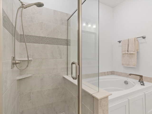 bathroom featuring independent shower and bath