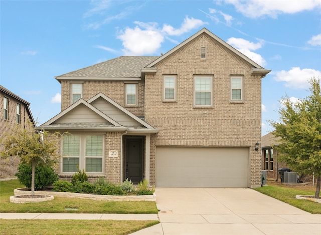 view of front of home featuring a garage and central air condition unit