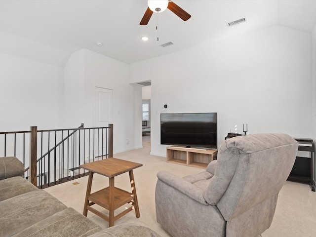 living room with light carpet, lofted ceiling, and ceiling fan