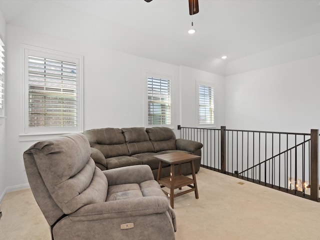 carpeted living room featuring ceiling fan