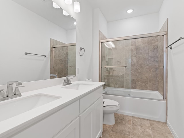 full bathroom featuring vanity, combined bath / shower with glass door, and toilet