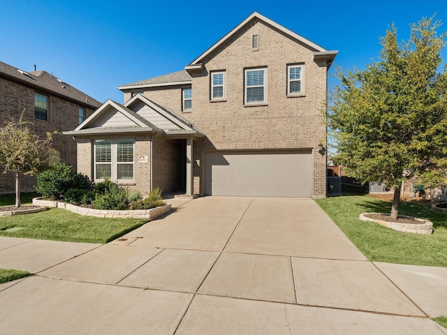 view of front of property with a front yard and a garage