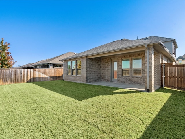 rear view of property with a patio area and a lawn