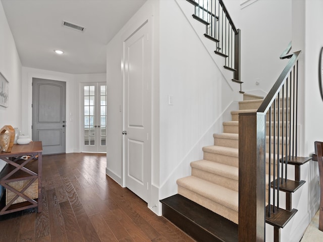 entryway with french doors and dark hardwood / wood-style floors