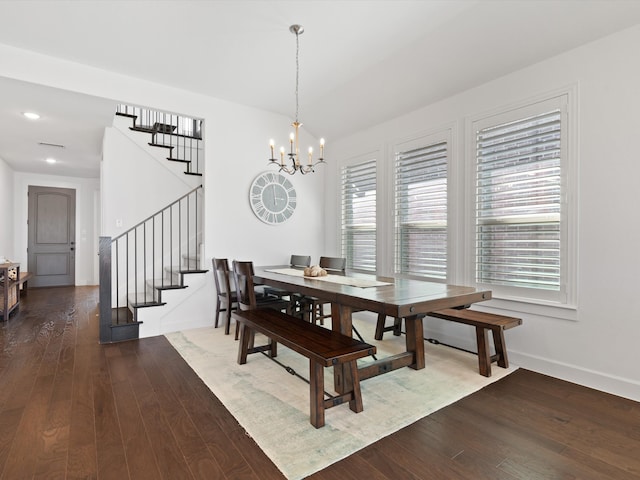 dining area featuring hardwood / wood-style flooring and a chandelier