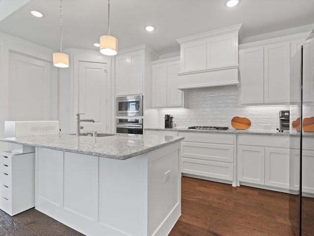 kitchen with sink, white cabinetry, hanging light fixtures, stainless steel appliances, and light stone counters