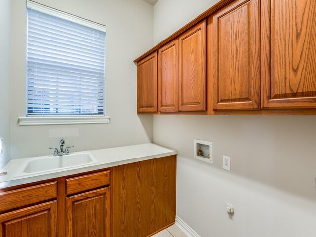 laundry area with a wealth of natural light, sink, hookup for a washing machine, and cabinets