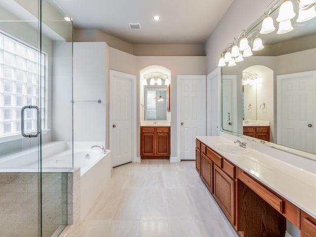 bathroom with vanity and independent shower and bath