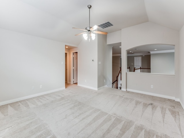 unfurnished room with vaulted ceiling, light colored carpet, and ceiling fan