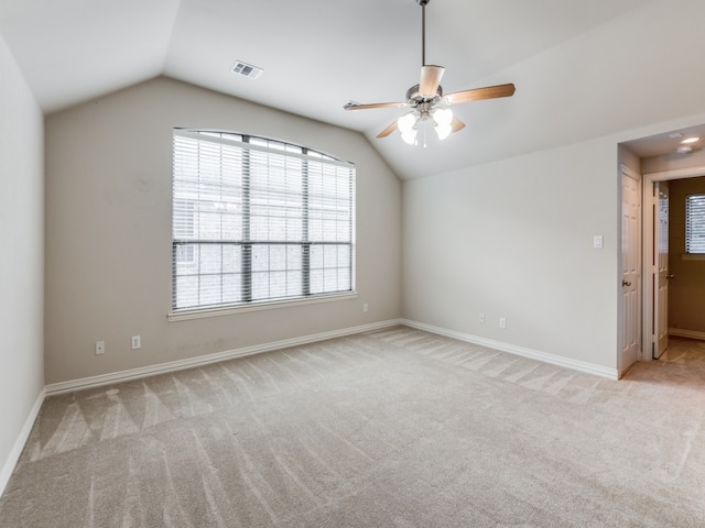 carpeted spare room with lofted ceiling and ceiling fan