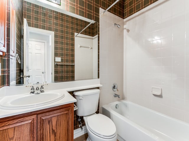 full bathroom with vanity, toilet, and tiled shower / bath combo