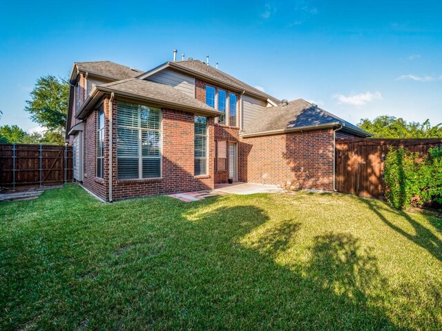 back of house with a yard and a patio area